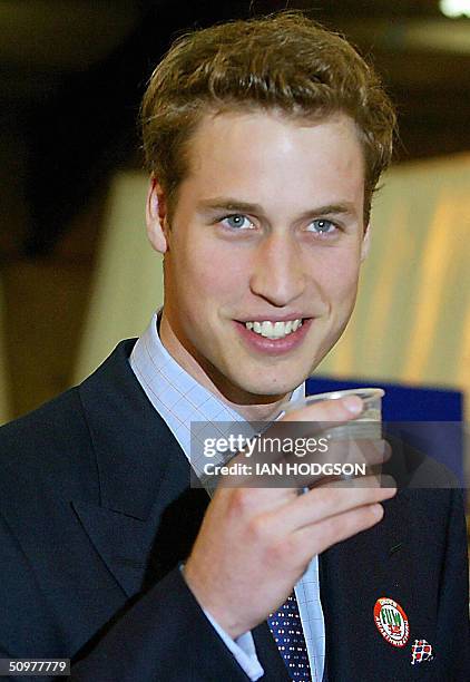 This file picture shows Britain's Prince William having a drink of beer on a visit to the Anglesey Agricultural centre, in Anglesey, Wales, 19 June...