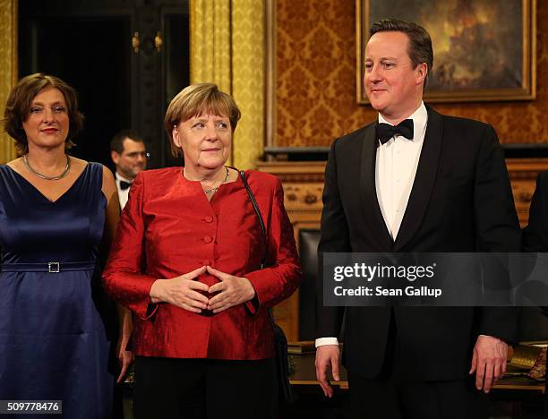 Britta Ernst British Prime Minister David Cameron and German Chancellor Angela Merkel attend the annual Matthiae-Mahl dinner at Hamburg City Hall on...