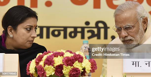 Prime Minister Narendra Modi talking to HRD Minister Smriti Irani during the Akhil Bharatiya Prachaarya Sammelan organized by the Vidya Bharati Akhil...