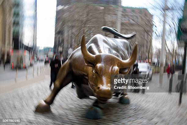 The famous bull sculpture stands near Wall Street in New York, U.S., on Friday, Feb. 12, 2016. U.S. Stocks halted a five-day slide that dragged...