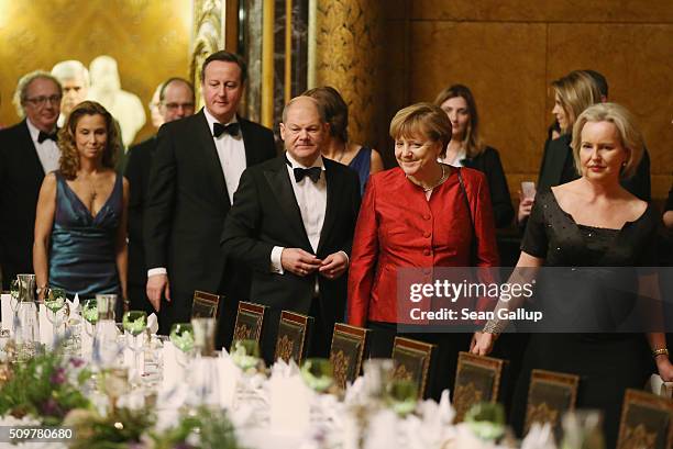 British Prime Minister David Cameron , Hamburg Mayor Olaf Scholz and German Chancellor Angela Merkel attend the annual Matthiae-Mahl dinner at...