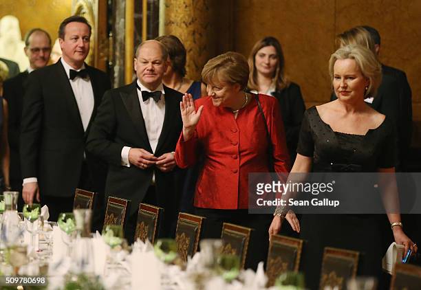 British Prime Minister David Cameron , Hamburg Mayor Olaf Scholz and German Chancellor Angela Merkel attend the annual Matthiae-Mahl dinner at...