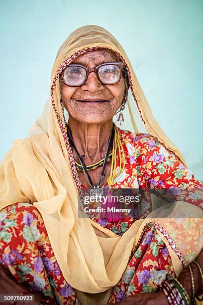 smiling senior indian woman, real people portrait - mlenny photography stock pictures, royalty-free photos & images