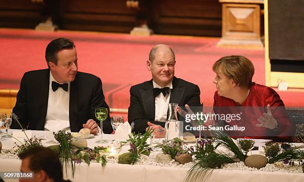 British Prime Minister David Cameron , German Chancellor Angela Merkel and Hamburg's Mayor Olaf Scholz attend the annual Matthiae-Mahl dinner at...