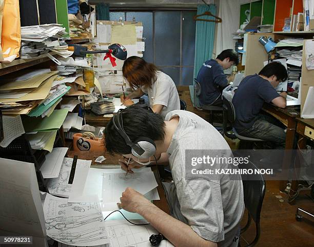 Japanese animators work to draw animation pictures for a movie at a production in an apartment in Tokyo, 05 June 2004. Japanese animation accounts...