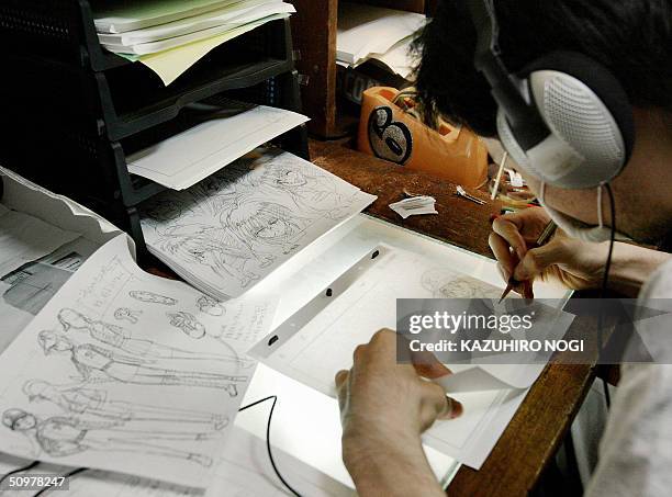 Japanese animator draws animation pictures for a movie at a production in an apartment in Tokyo, 05 June 2004. Japanese animation accounts for 60...