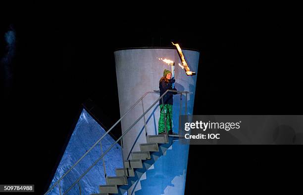 In this handout image supplied by the IOC, Her Royal Highness Princess Ingrid Alexandra of Norway lights the cauldron during the Opening Ceremony of...