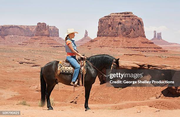 cowgirl on john ford point in monument valley - cow girl stock pictures, royalty-free photos & images