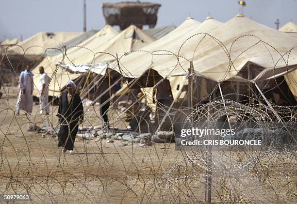 Military review board plays jury to Iraq's 6,000 detainees by Ned Parker Iraqi prisoners at Camp Gancy wait to be relocated to a better location...