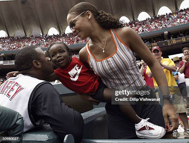 Ken Griffey Jr. #30 of the Cincinnati Reds kisses his two-year-old son Tevin, held by his wife Melissa, after hitting his 500th career home run in...