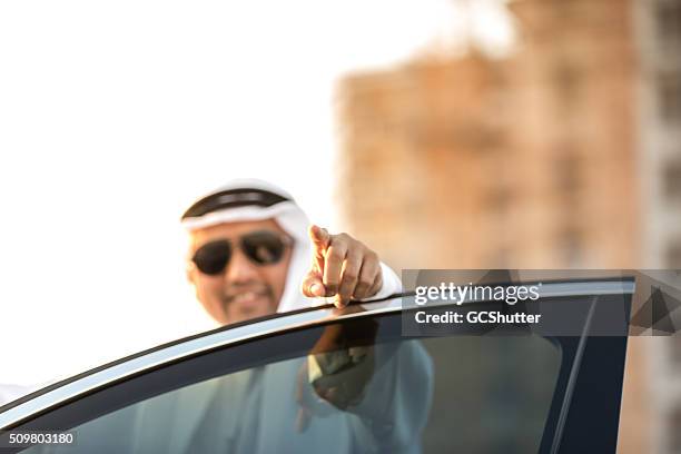 arab businessman pointing towards camera - ghoutra stock pictures, royalty-free photos & images