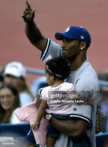 Kobe Bryant of the Los Angeles Lakers waves to fans during the Los Angeles Dodgers versus New York Yankees game on June 20, 2004 at Dodger Stadium in...