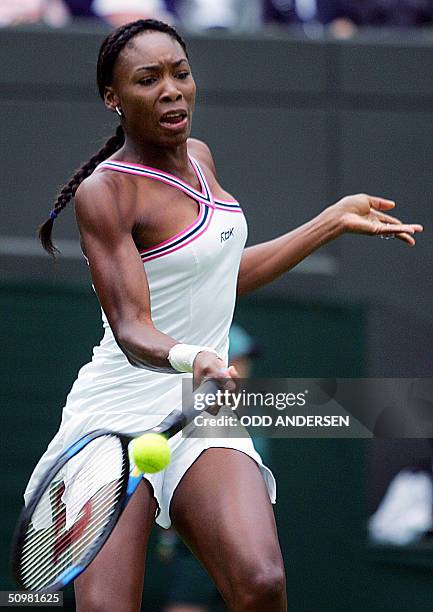 Venus Williams of the US hits a forehand to Marie-Gayanay Mikaelian of Switzerland during the first round of the 118th Wimbledon Tennis Championships...