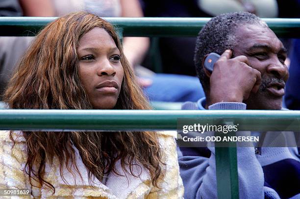Serena Williams and her father Richard watch Venus Williams of the US play against Marie-Gayanay Mikaelian of Switzerland during the first round of...