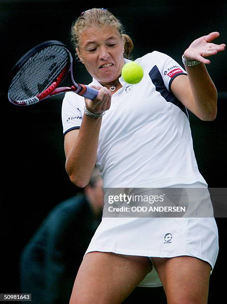 Marie-Gayanay Mikaelian of Switzerland hits a forehand to Venus Williams of the US during the first round of the 118th Wimbledon Tennis Championships...