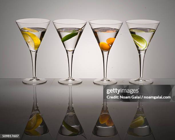 alcoholic cocktails in martini glasses - 4 cocktails stockfoto's en -beelden