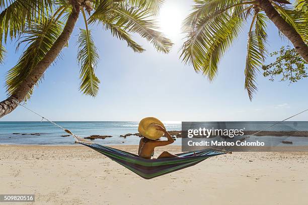woman relaxing on hammock under palm tree on a tropical beach, fiji - fiji relax stock pictures, royalty-free photos & images