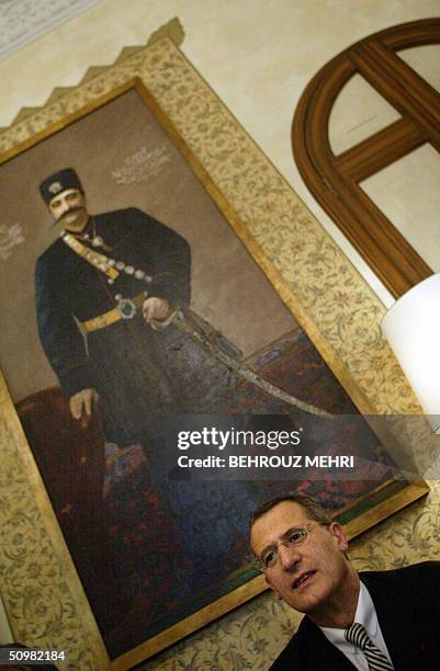 French President of Air France, Jean-Cyril Spinetta, speaks with journalists under a painting of Iran's Qajar Dynasty king Nasereddin Shah, who...