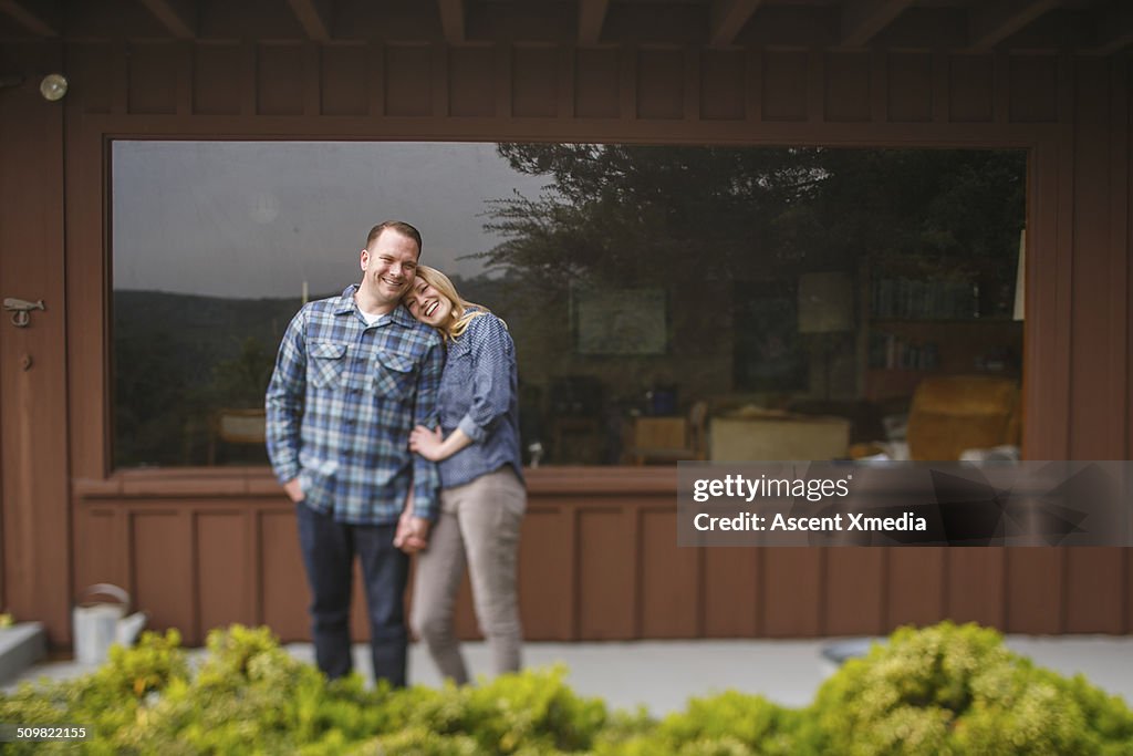 Couple share happy moment outside of home