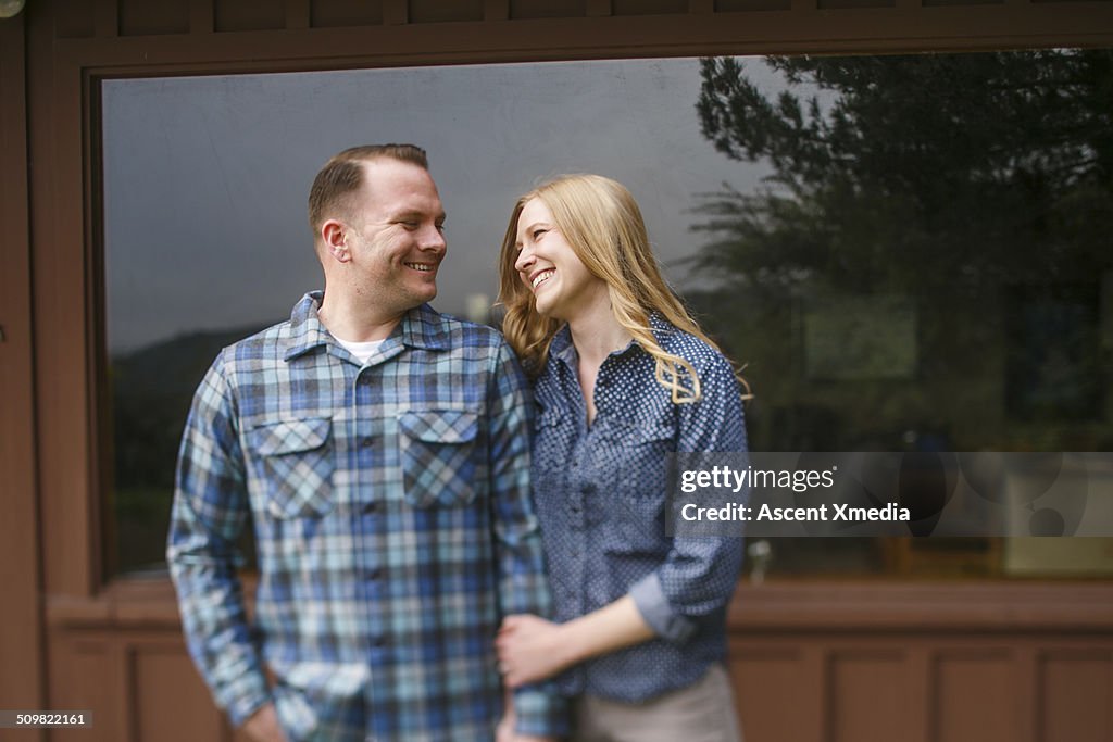 Couple share happy moment outside of home