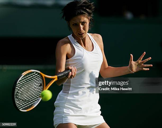 Anastasia Myskina of Russia in action during her first round match against Lubomira Kurhajcova of Slovakia at the Wimbledon Lawn Tennis Championship...