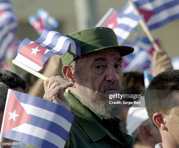 Cuban President Fidel Castro waves a Cuban flag during a demonstration outside the U.S. Interest Section June 21, 2004 in Havana, Cuba. Castro...