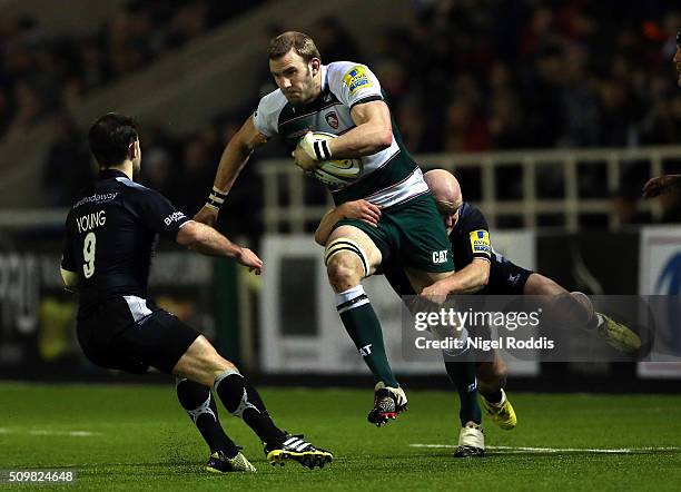 Tom Croft of Leicester Tigers tackled by Michael Young and Scott Lawson of Newcastle Falcons during the Aviva Premiership match between Newcastle...