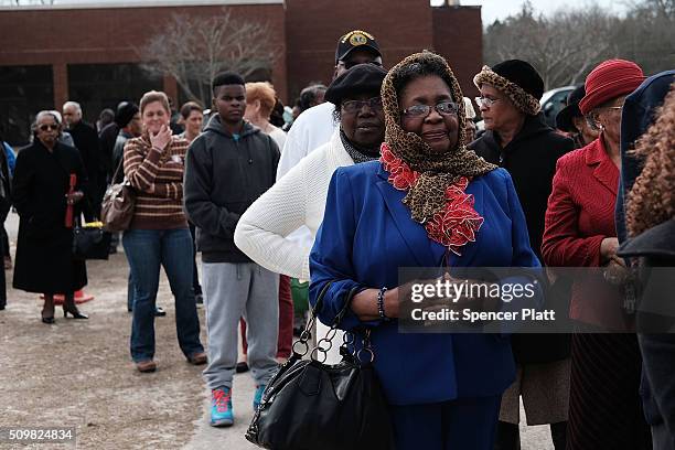 Residents wait to get into a school to see Democratic presidential candidate Hillary Clinton speak in South Carolina a day after her debate with...