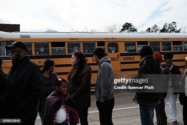 Residents wait to get into a school to see Democratic presidential candidate Hillary Clinton speak in South Carolina a day after her debate with...