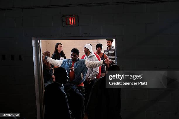 Residents go through security before getting into a school to see Democratic presidential candidate Hillary Clinton speak in South Carolina a day...