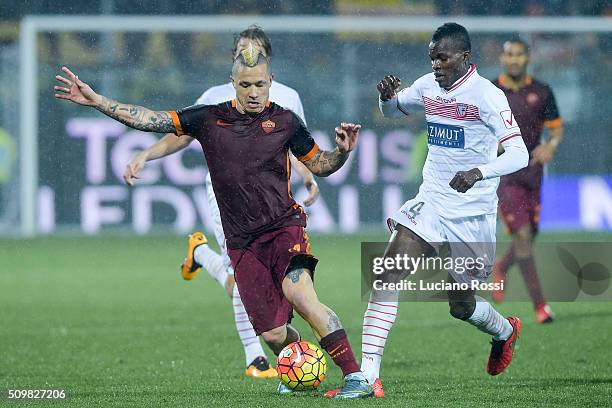 Roma player Radja Nainggolan is challenged by Carpi FC player Isaac Cofie during the Serie A match between Carpi FC and AS Roma at Alberto Braglia...