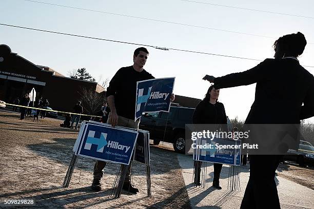 Campaign workers pass out signs following an appearance by Democratic presidential candidate Hillary Clinton in South Carolina a day after her debate...