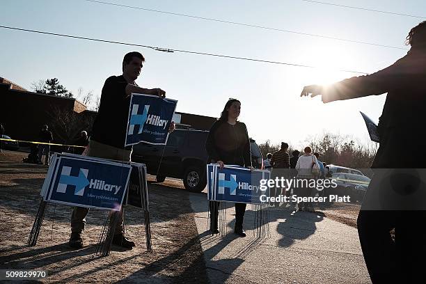 Campaign workers pass out signs following an appearance by Democratic presidential candidate Hillary Clinton in South Carolina a day after her debate...