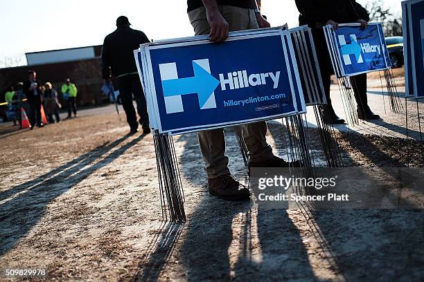 Campaign workers pass out signs following an appearance by Democratic presidential candidate Hillary Clinton in South Carolina a day after her debate...