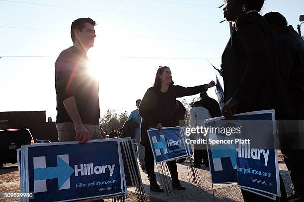 Campaign workers pass out signs following an appearance by Democratic presidential candidate Hillary Clinton in South Carolina a day after her debate...