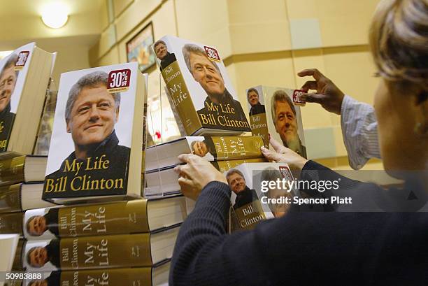 As eager customers wait, Barnes and Noble employees place the new Bill Clinton autobiography "My Life" on the shelves June 21, 2004 in New York City....