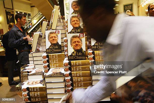 As eager customers wait, Barnes and Noble employees place the new Bill Clinton autobiography "My Life" on the shelves June 21, 2004 in New York City....