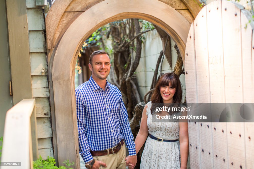 Portrait of happy couple in outdoor home archway