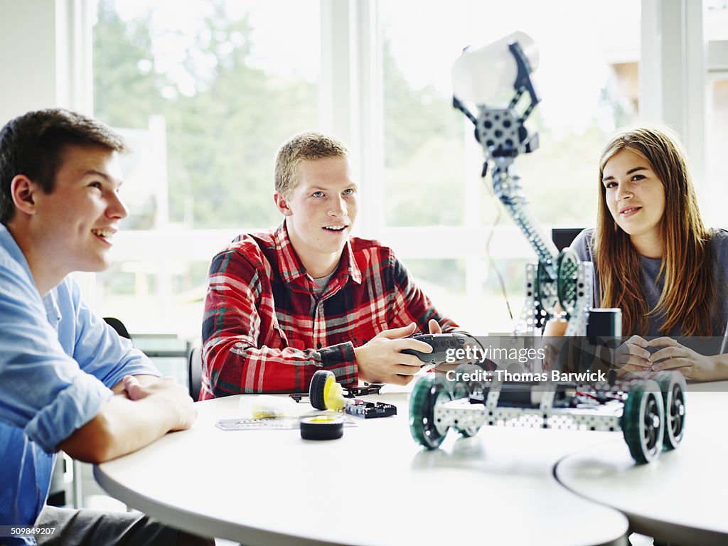 Student using remote control to operate robot