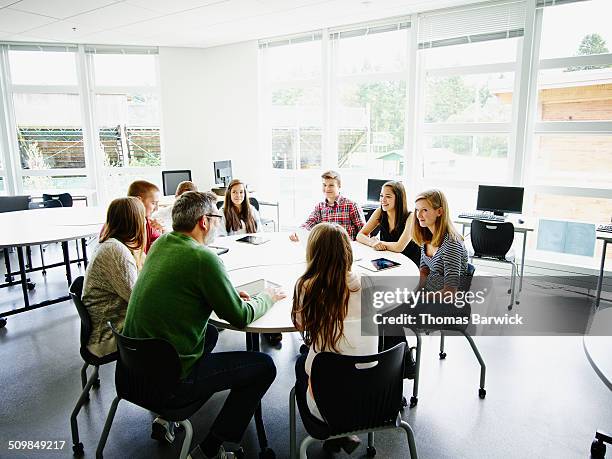 students in discussion with teacher in classroom - juventus v fc bayern muenchen uefa champions league round of 16 stockfoto's en -beelden