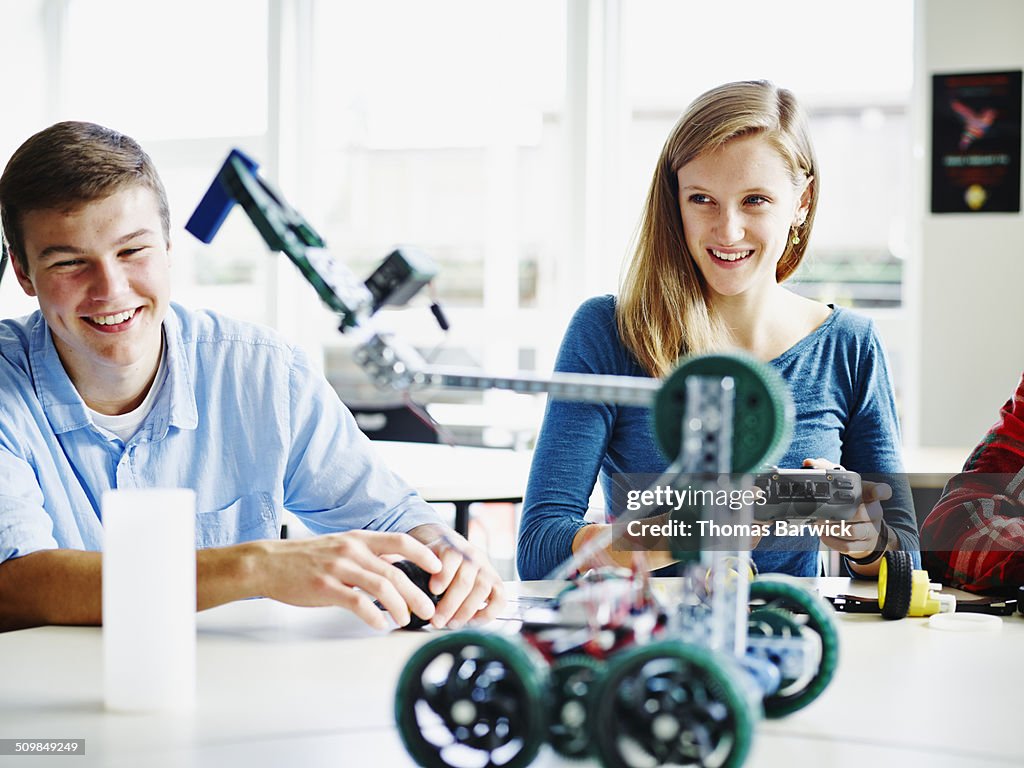 Students using remote control to operate robot