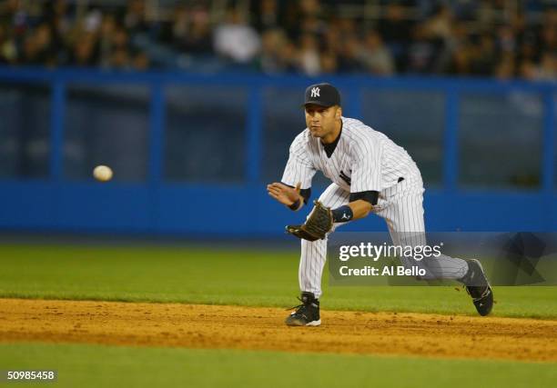Derek Jeter of the New York Yankees fields a ground ball during the game against the Oakland A's on April 27, 2004 at Yankee Stadium in the Bronx,...