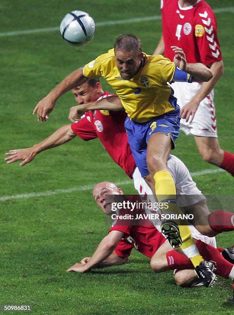 Sweden's defender Olof Mellberg goes for a head, 22 June 2004 during their Euro 2004 football match at the Bessa stadium in Porto. Denmark and Sweden...