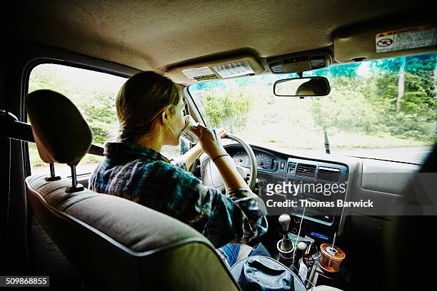 female farmer drinking coffee in pickup truck - drink driving stockfoto's en -beelden