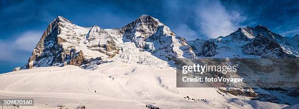 snowy winter mountain peaks panorama eiger north face alps switzerland - eiger mönch jungfrau stock pictures, royalty-free photos & images