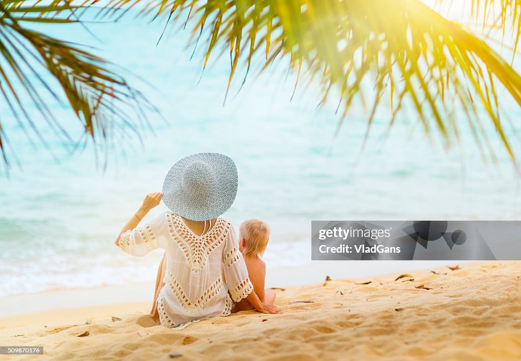 Mother with baby at tropical beach