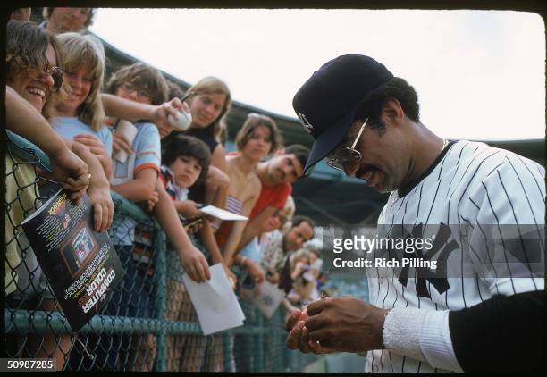 Reggie Jackson of the New York Yankees signs autographs for the fans in 1979.