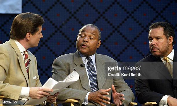 Matt Devlin, Bernie Bickerstaff, and Ed Tapscott of the Charlotte Bobcats talk during the expansion draft on June 22, 2004 at the Founders Hall in...