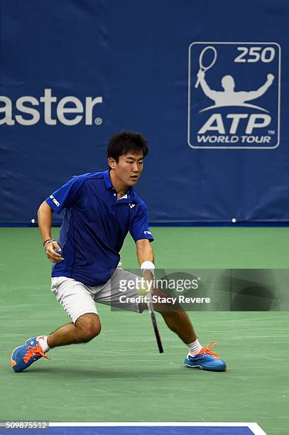 Yoshihito Nishioka of Japan returns a shot to Sam Querrey of the United States during their quarterfinal singles match on Day 5 of the Memphis Open...