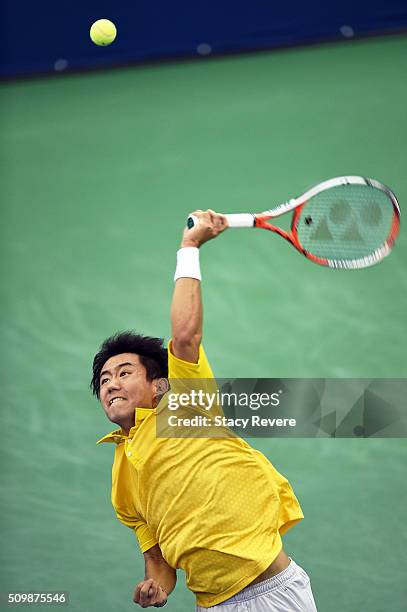 Yoshihito Nishioka of Japan serves to Sam Querrey of the United States during their quarterfinal singles match on Day 5 of the Memphis Open at the...